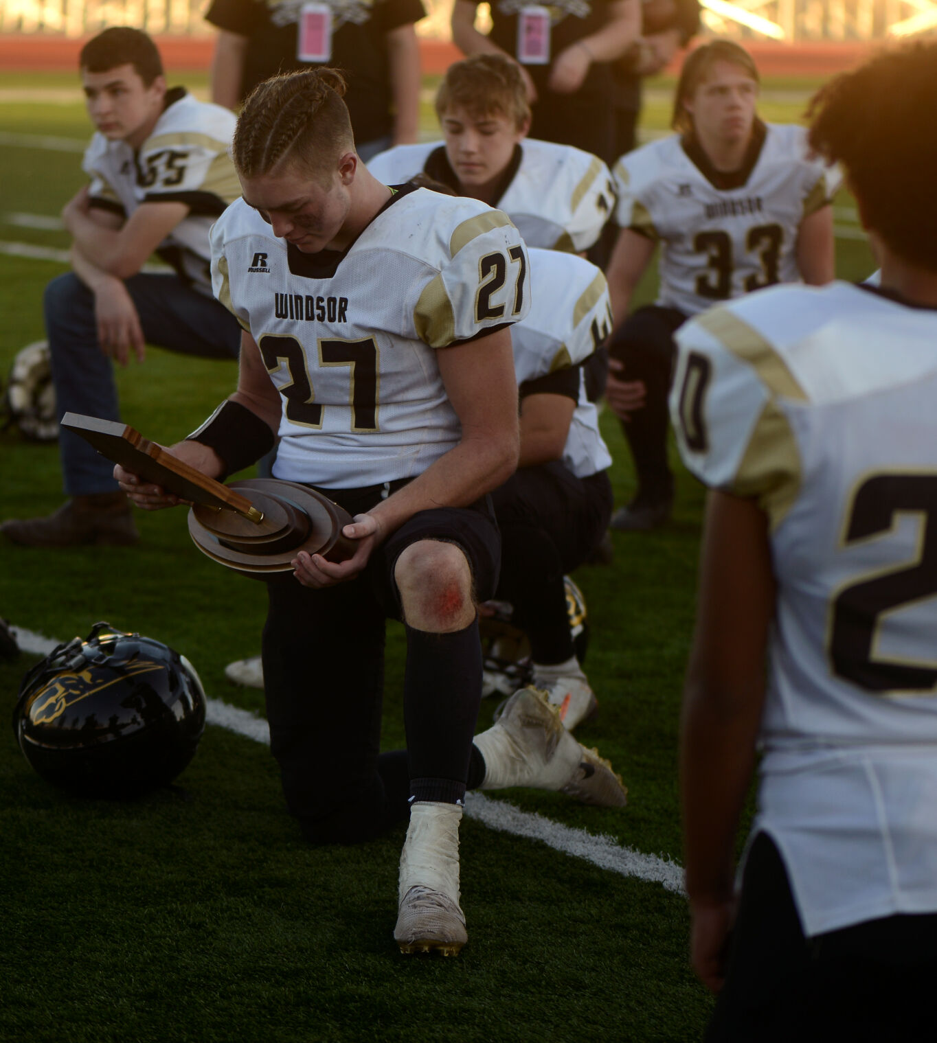 Jake Wheatley inspects his team’s state championship trophy